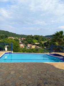 a swimming pool with a view of a city at Pousada Espaço Cosmos in Águas da Prata