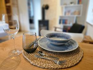 a table with a bowl and a wine glass at [H]auszeit Bad Nenndorf in Bad Nenndorf