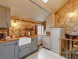 a kitchen with a sink and a counter top at 1 Bed in Longborough 52674 in Longborough