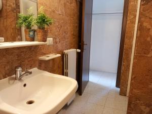 a bathroom with a sink and a mirror at Menhir in Tempio Pausania