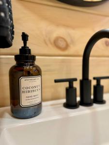 a bottle of soap sitting on top of a sink at Brook Haven Retreat - Minutes to Mt Snow / Stratton, Pet Friendly! in Wardsboro