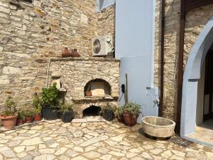 a stone brick oven with pots of plants on it at Charming 1800s House - Lefkara Village Retreat in Pano Lefkara