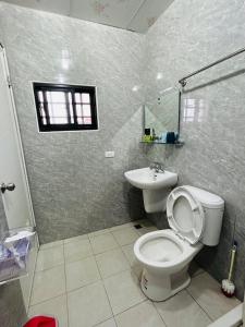 a bathroom with a toilet and a sink at Hello in Fangliao
