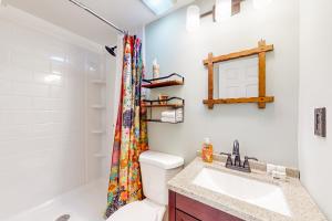 a bathroom with a sink and a shower curtain at Cozy Mountain Getaway in Proctorsville +25 photos