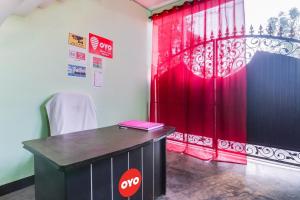 a table in a room with a red curtain at Relax Inn Hotel in Lucknow