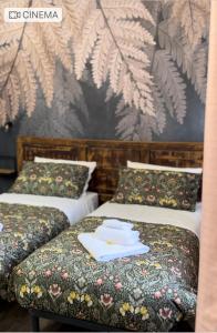 duas camas num quarto de hotel com toalhas em B&B La Fenice em Bolonha