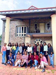 a group of people posing in front of a house at COORG STONE VILLA in Madikeri