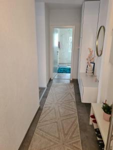 einen Flur mit Fliesenboden und einer Tür zum Bad in der Unterkunft Apartment Merry - Free private Parking & Garage in Mostar