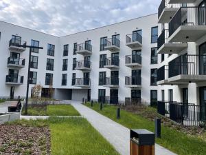an exterior view of a white building at Wygodne Mieszkania Nova Mikołowska 123 in Katowice
