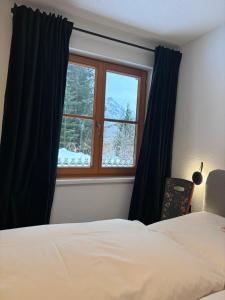 - une chambre avec un lit et une fenêtre dans l'établissement Haus Drescher, à Leutasch
