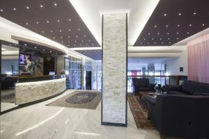 a lobby with a stone pillar in a building at Hotel King in Alba Adriatica