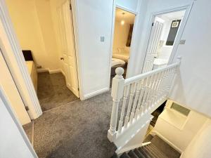 a hallway with a stairway leading to a bedroom at 3 bedroom garden house Maida Vale in London