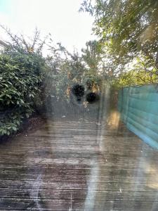a blurry picture of a walkway with a fence at 3 bedroom garden house Maida Vale in London