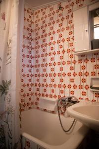 a bathroom with a shower curtain and a sink at Traditional County House close to Trikala 