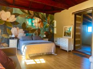 a bedroom with a flower mural on the wall at Villa tegueste in Tegueste