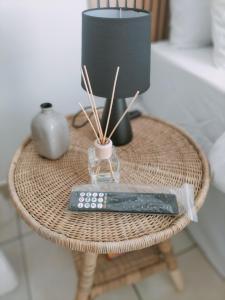 a wicker table with a remote control on it at The protea nest in Johannesburg