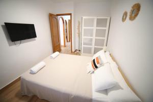 Łóżko lub łóżka w pokoju w obiekcie Casa de playa, cerca de todo