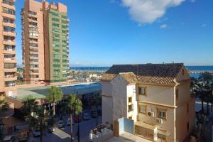 a view of a city with a building and buildings at Apartamento con vistas al mar in Fuengirola