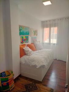 a bedroom with a bed in a room with a window at Piso turistico el Sol VUT-983 in Astorga