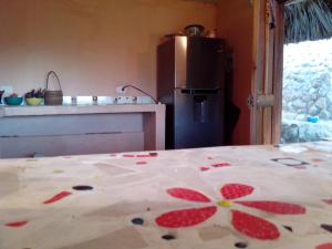 a kitchen with a table with a flower pattern on it at Exclusive EcoHouse & SeaView in Palomino