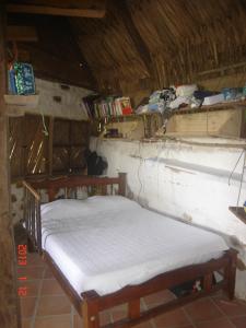 a room with a bed and shelves in a cabin at Exclusive EcoHouse & SeaView in Palomino