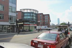 a red car is parked on a city street at West Broadway Quarters by Thatch in Boston
