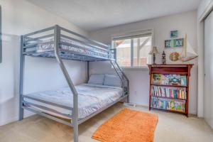 a bedroom with a bunk bed and a book shelf at Casa Vista del Mar in Lincoln City