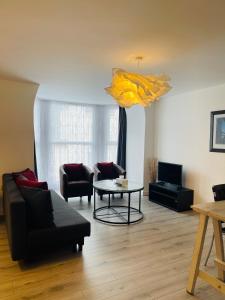 a living room with a couch and a table at One bedroom apartment, no 4 in Ilfracombe