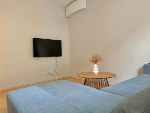 聖珀爾滕的住宿－City Apartment Sankt Pölten，客房设有两张床和一台墙上的电视。