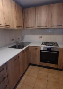 an empty kitchen with a stove and a sink at Casa Adile in Sappada