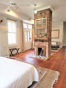 a living room with a fireplace and a bed at Kelley House in Pensacola