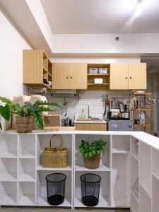 a kitchen with white cabinets and potted plants at Affordable Condo beside Ayala Mall Bacolod! in Bacolod