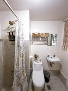 a bathroom with a toilet and a sink at Affordable Condo beside Ayala Mall Bacolod! in Bacolod