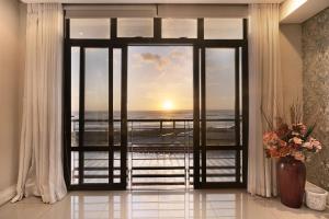 a room with a window with a view of the ocean at Eden on the Bay 167 by HostAgents in Bloubergstrand