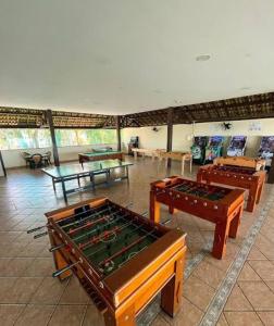 a room with ping pong tables and ping pong balls at Vista serra, praia e mar in Mangaratiba
