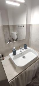 a white bathroom with a sink and a mirror at Maison de Marie in Trani +46 photos