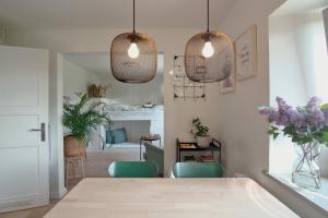 a dining room with a table and two pendant lights at Elbblick in Hamburg