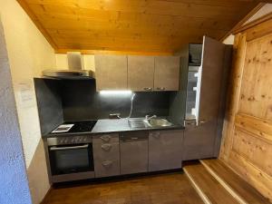 a kitchen with a sink and a stove at Gästehaus Katharina in Hochfilzen
