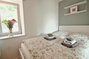 a bedroom with a bed with a vase of flowers at Elbblick in Hamburg