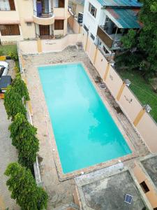 an overhead view of a large swimming pool in a building at 3 bedroom Nyali apartment in Mombasa