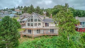 an aerial view of a large house on a hill at Pelican Villa - Meredith Lodging in Pacific City