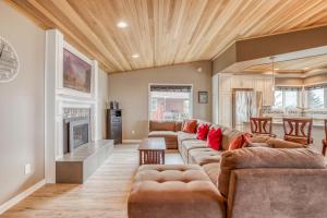 a living room with a couch and a fireplace at Pelican Villa - Meredith Lodging in Pacific City
