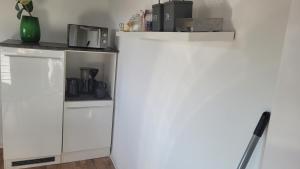 cocina con armarios blancos y encimera en Appartment B 40, en Pirmasens