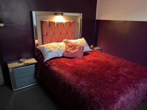 a bedroom with a bed with a large mirror at Casa Matamoros in Morelia