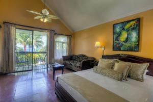 a bedroom with a large bed and a large window at Hotel Cuna del Angel in Dominical