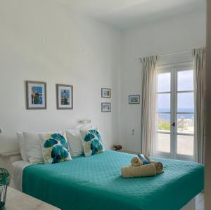 a bedroom with a bed with a teddy bear on it at Captain's in Kinion