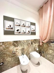 a bathroom with a toilet and a sink at Aristocasa luxury rooms in Palermo +35 photos