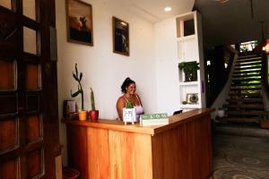a woman sitting at a counter in a room at Alma Olon in Olón