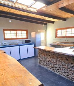 a large kitchen with a large counter in a room at Goedgeloof Farm Stay in Barrydale