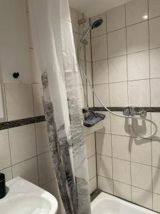 a bathroom with a shower and a sink at Urlaub im historischen Müllerhaus, Dachgiebel in Lübeck